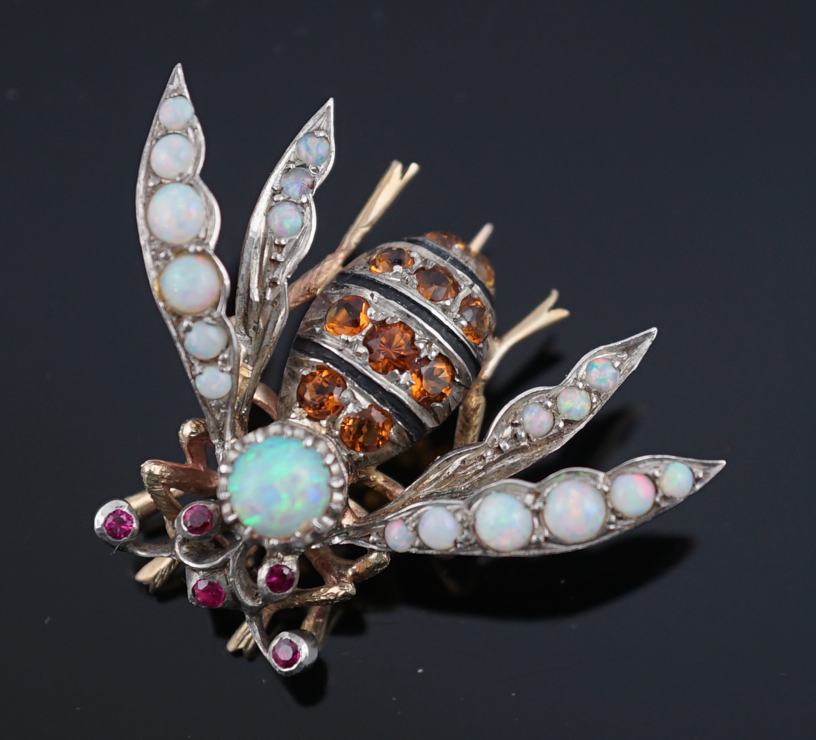 A late Victorian gold and silver, white opal, ruby and citrine? cluster set bug brooch